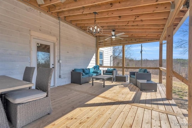 wooden terrace featuring outdoor lounge area and ceiling fan