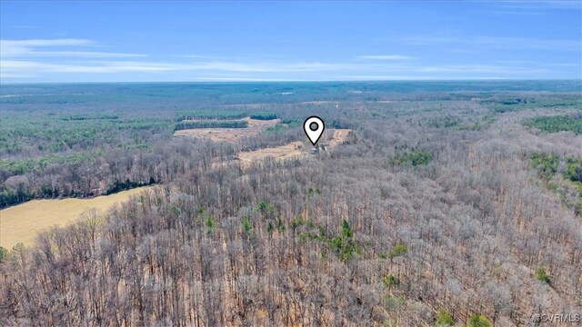 birds eye view of property featuring a wooded view