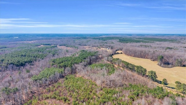 birds eye view of property featuring a view of trees