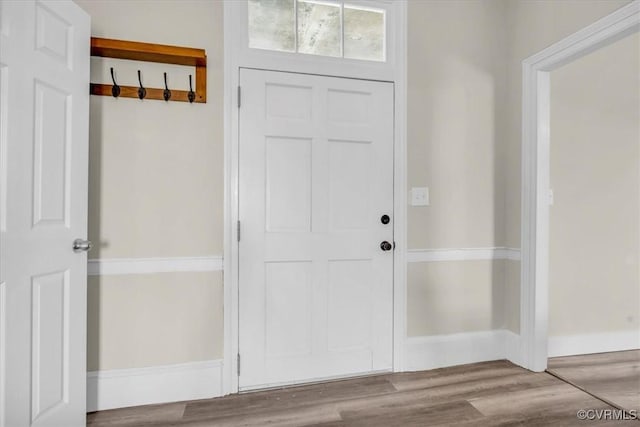 interior space featuring baseboards and wood finished floors