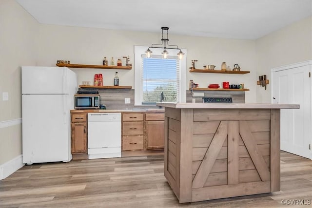 kitchen with decorative light fixtures, light wood finished floors, open shelves, light countertops, and white appliances