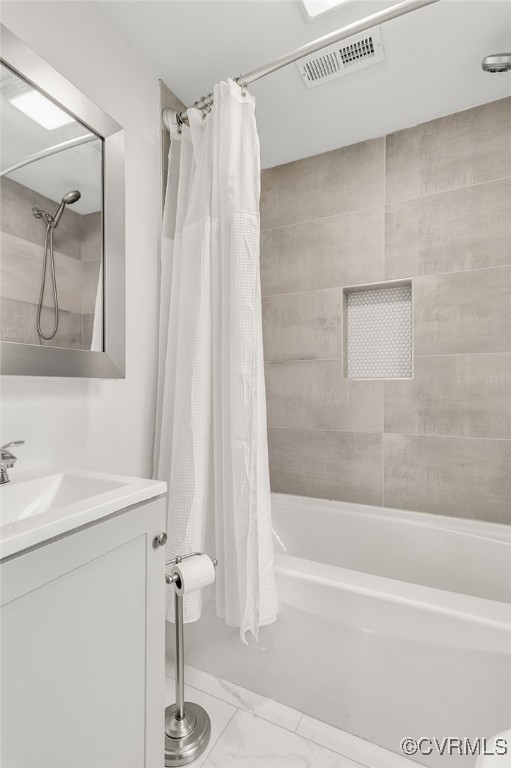 bathroom with marble finish floor, shower / bathtub combination with curtain, visible vents, and vanity