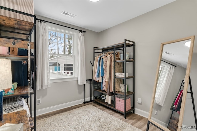 spacious closet featuring visible vents and wood finished floors