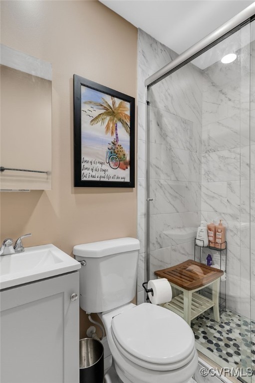 bathroom featuring a stall shower, vanity, and toilet