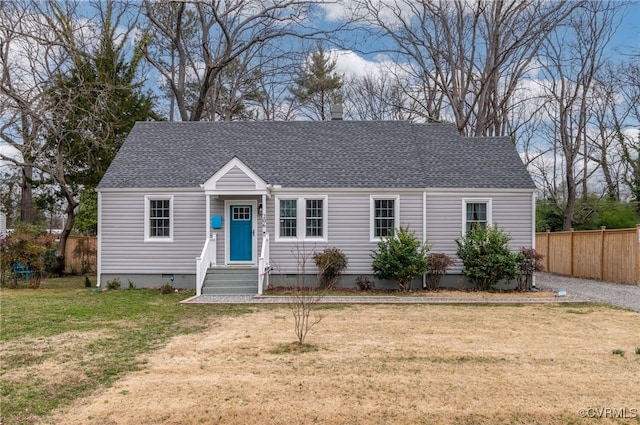 view of front facade featuring a shingled roof, crawl space, a front yard, and fence