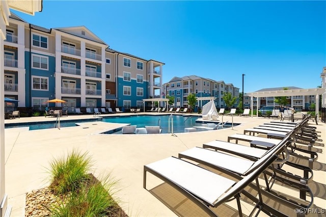 pool featuring a residential view and a patio