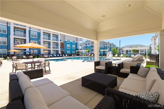 view of patio / terrace featuring a community pool and outdoor lounge area