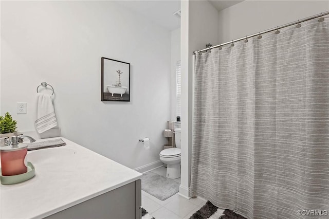 bathroom with baseboards, toilet, a shower with curtain, tile patterned floors, and vanity