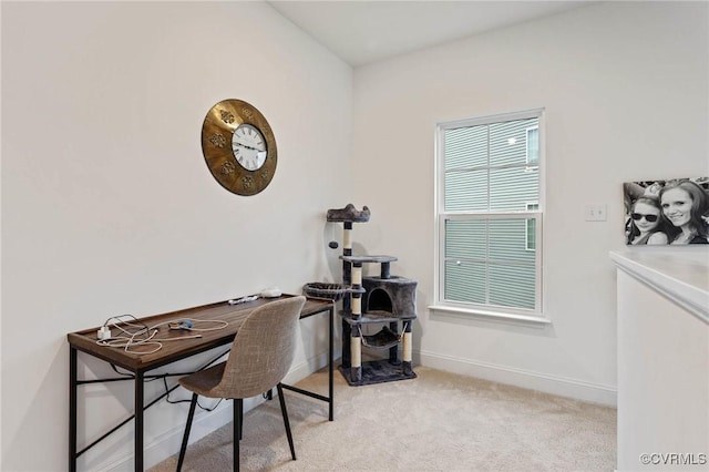 office space with baseboards and light colored carpet