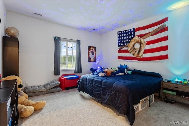 carpeted bedroom featuring visible vents