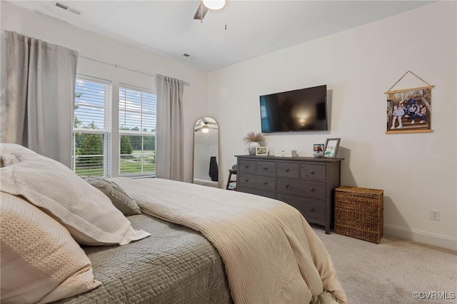 bedroom with carpet floors, baseboards, visible vents, and a ceiling fan