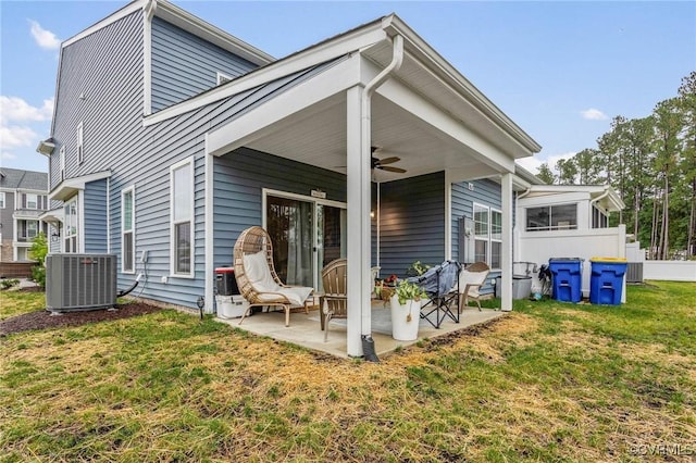 rear view of property with ceiling fan, central AC unit, a lawn, and a patio