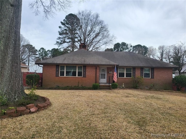 ranch-style house with crawl space, brick siding, a chimney, and a front yard