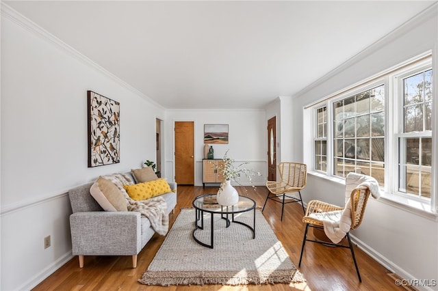 living room with ornamental molding, wood finished floors, and a wealth of natural light