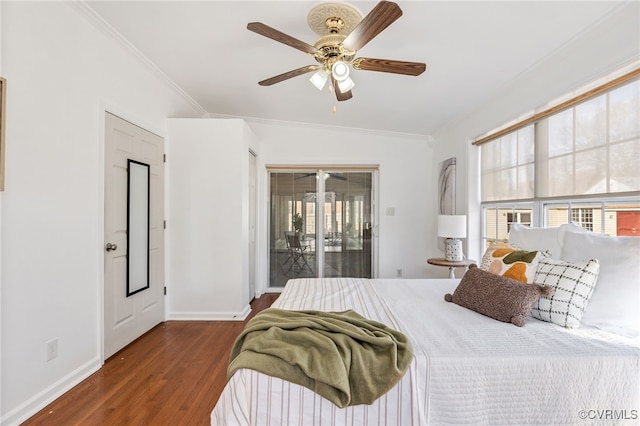 bedroom featuring access to exterior, crown molding, baseboards, and wood finished floors