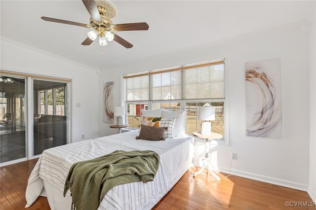 bedroom featuring ornamental molding, access to outside, baseboards, and hardwood / wood-style flooring