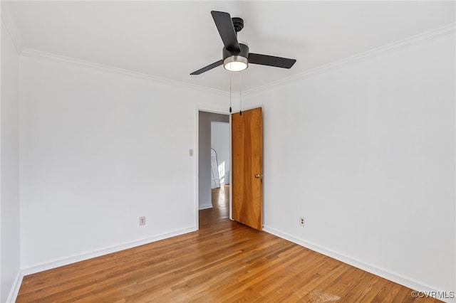 unfurnished room with ceiling fan, ornamental molding, light wood-type flooring, and baseboards