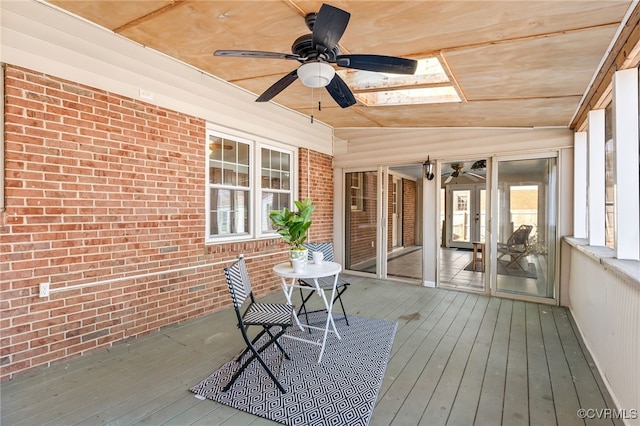 unfurnished sunroom with lofted ceiling and ceiling fan