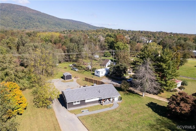 drone / aerial view with a mountain view and a forest view