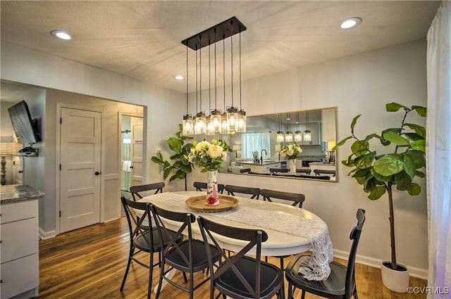 dining room featuring dark wood-style floors, recessed lighting, and baseboards