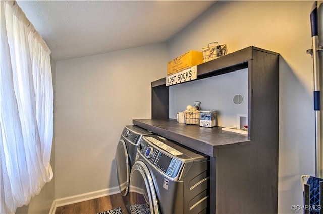 laundry room with baseboards, laundry area, wood finished floors, and washer and dryer