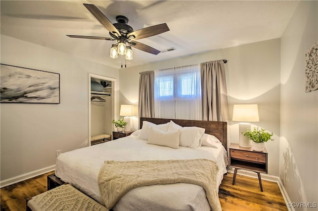 bedroom with a ceiling fan, baseboards, and wood finished floors