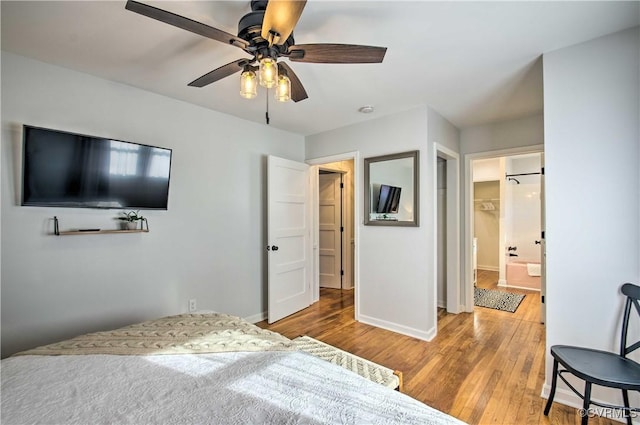 bedroom with ceiling fan, baseboards, and wood finished floors