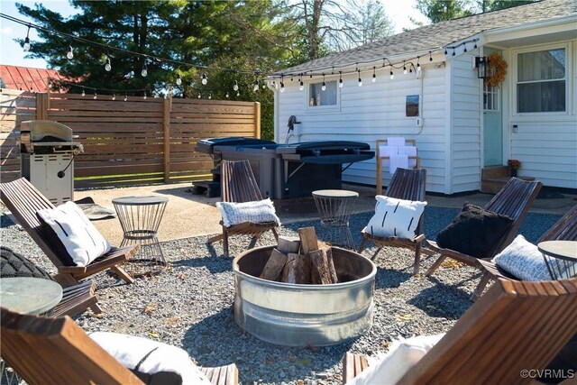 view of patio featuring fence, a fire pit, and area for grilling