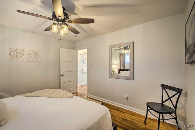 bedroom with a ceiling fan, baseboards, and wood finished floors