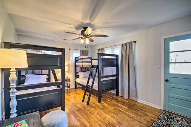 bedroom with baseboards and wood finished floors