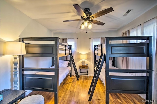 unfurnished bedroom featuring visible vents and wood finished floors