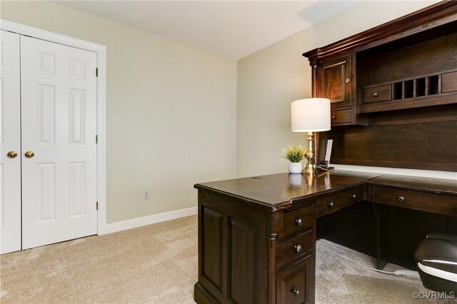 office featuring baseboards and light colored carpet