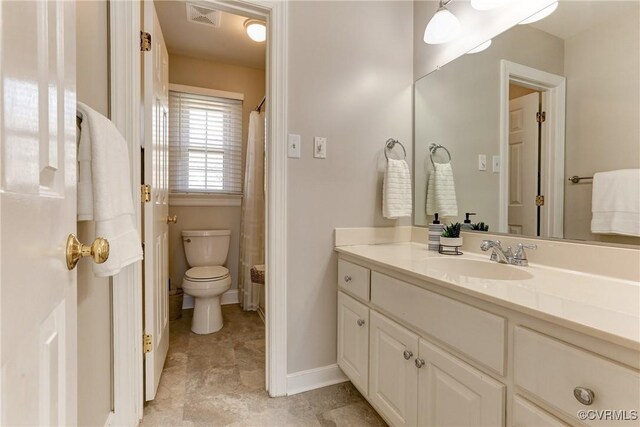 bathroom with baseboards, visible vents, vanity, and toilet