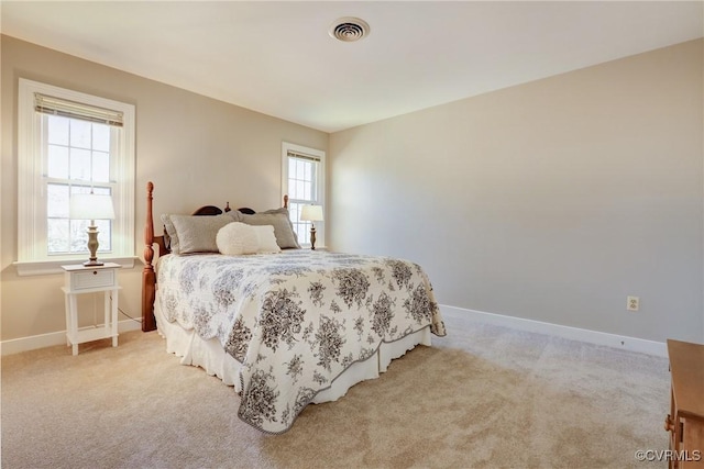 carpeted bedroom with baseboards and visible vents