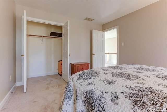 bedroom with a closet, light carpet, visible vents, and baseboards