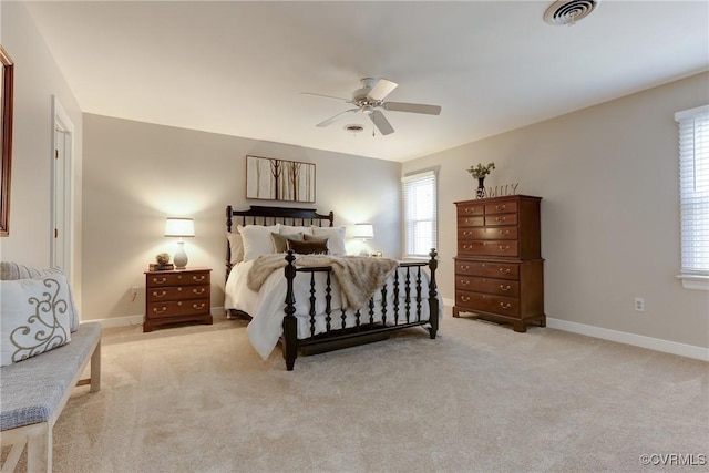 bedroom featuring light carpet, a ceiling fan, visible vents, and baseboards