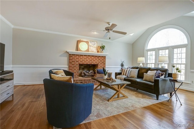 living room with plenty of natural light, wood finished floors, and wainscoting