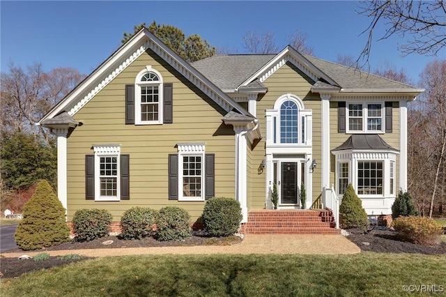 traditional home with roof with shingles