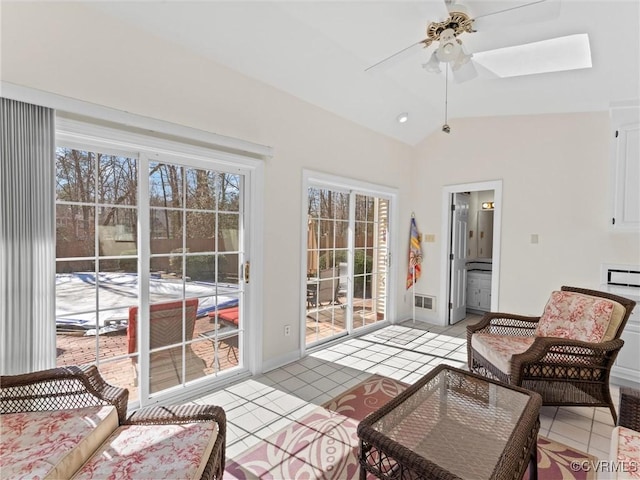 sunroom with lofted ceiling, visible vents, and ceiling fan