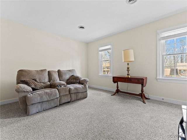 living room featuring a wealth of natural light, visible vents, and baseboards