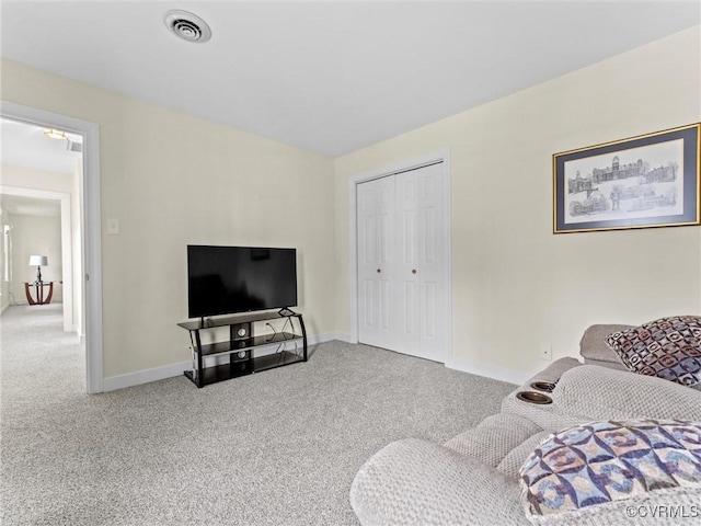 living area with carpet flooring, visible vents, and baseboards