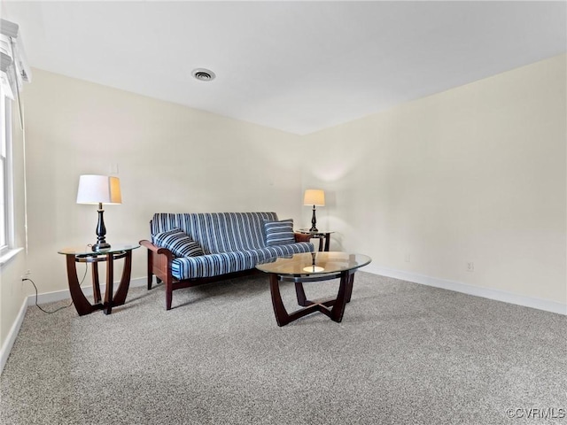 carpeted living area with visible vents and baseboards