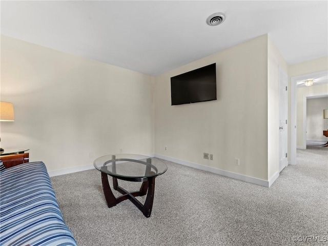 carpeted living room featuring baseboards