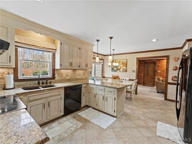 kitchen with ornamental molding, a peninsula, black appliances, pendant lighting, and a sink