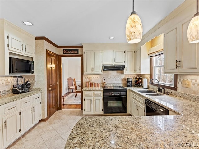 kitchen featuring light stone counters, ornamental molding, a sink, under cabinet range hood, and black appliances