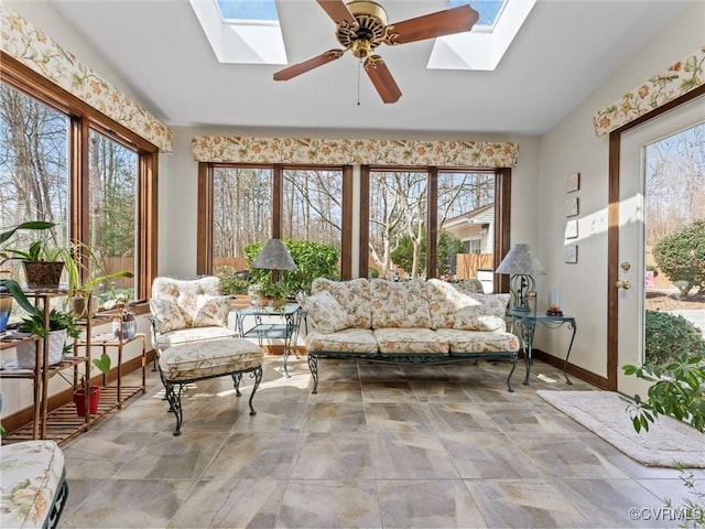 sunroom featuring ceiling fan and lofted ceiling with skylight