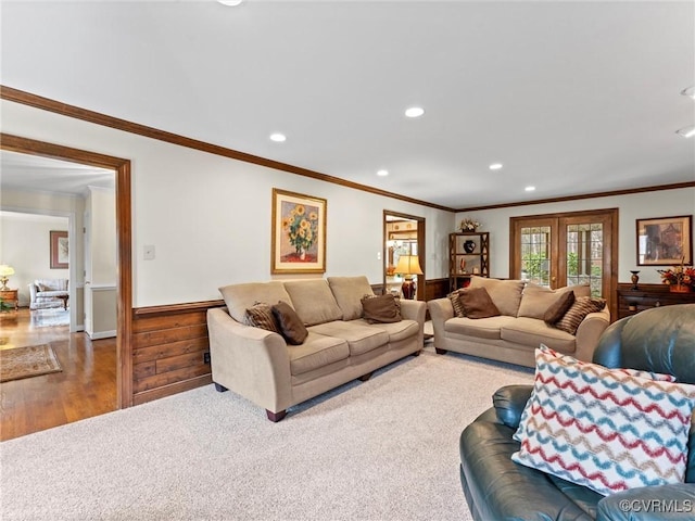 carpeted living area featuring a wainscoted wall, ornamental molding, wood finished floors, and recessed lighting