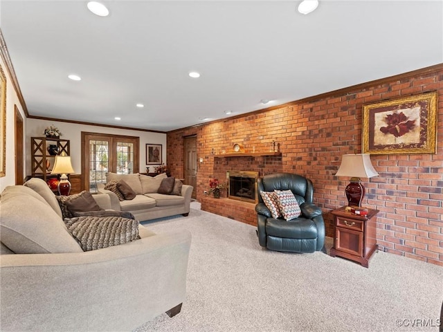 carpeted living room with brick wall, a fireplace, and crown molding