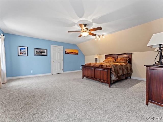 bedroom with lofted ceiling, ceiling fan, light carpet, and baseboards