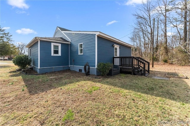 view of side of home with a lawn